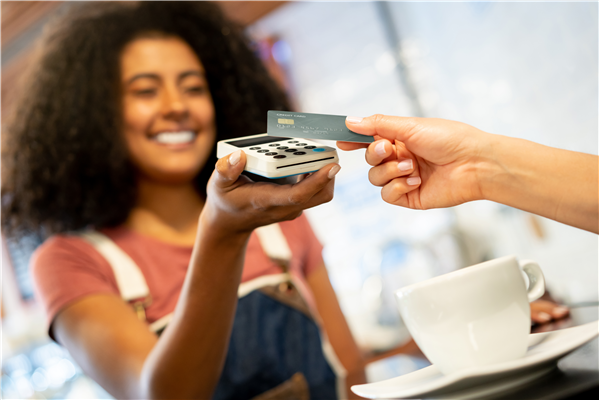 Making a purchase at a local coffee shop while using the new debit card from InCENTIV Checking