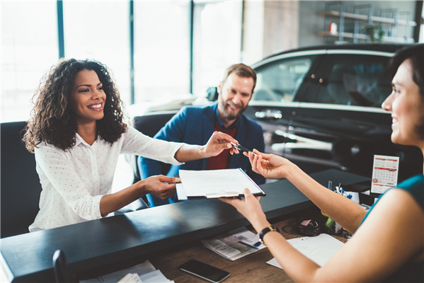 Couple signs the purchase agreement from the car lender in East Chicago, Indiana