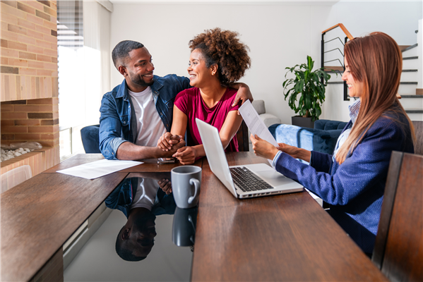 Couple meeting with an equity loan provider to discuss their options.