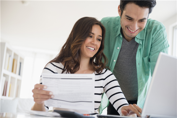 Husband and wife looking at their online bank account from Tech Credit Union